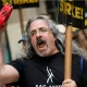 Striking writers and actors chant as they walk a picket line. (Image: AP)